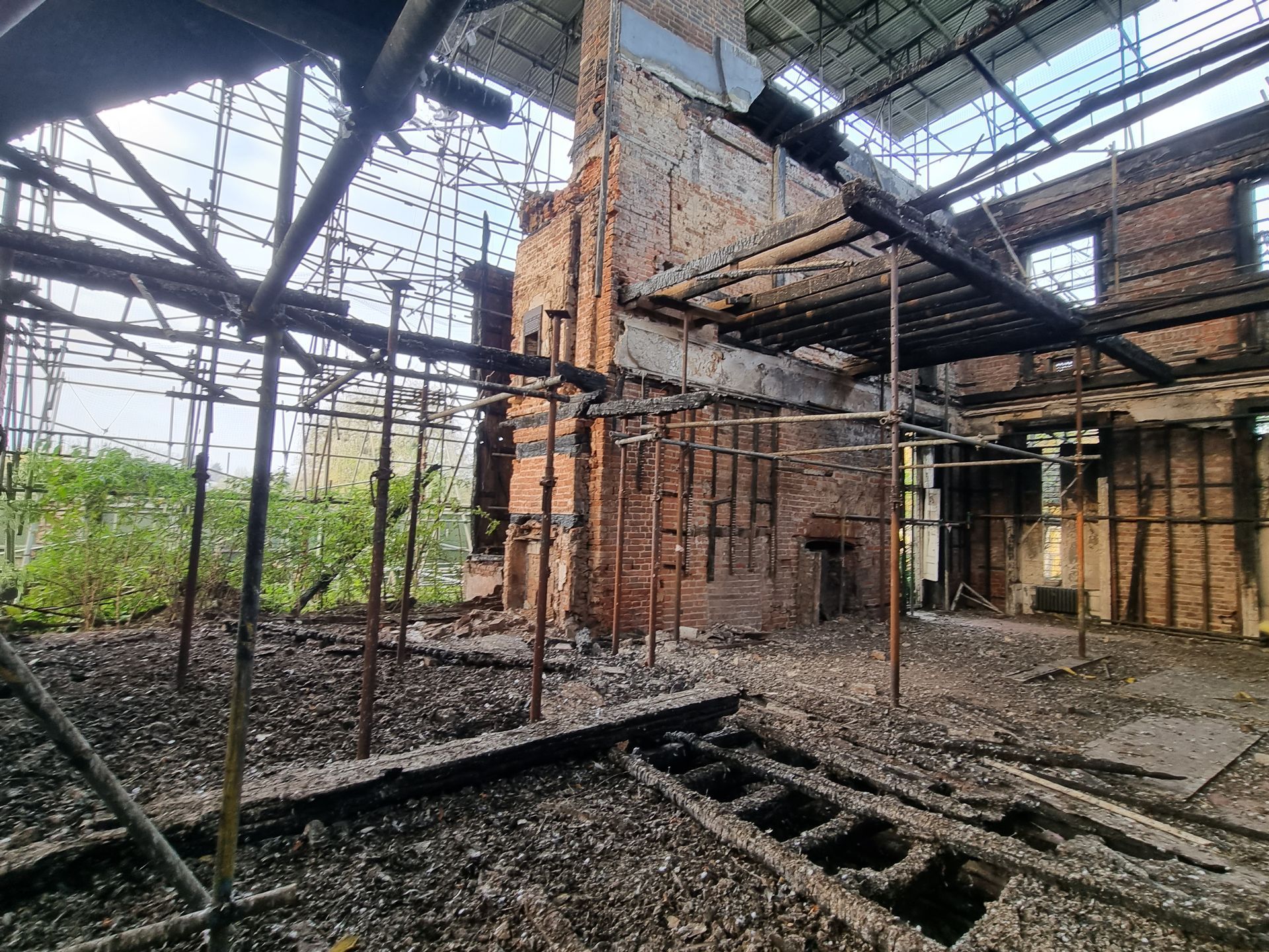 The inside of an abandoned building with a lot of scaffolding.