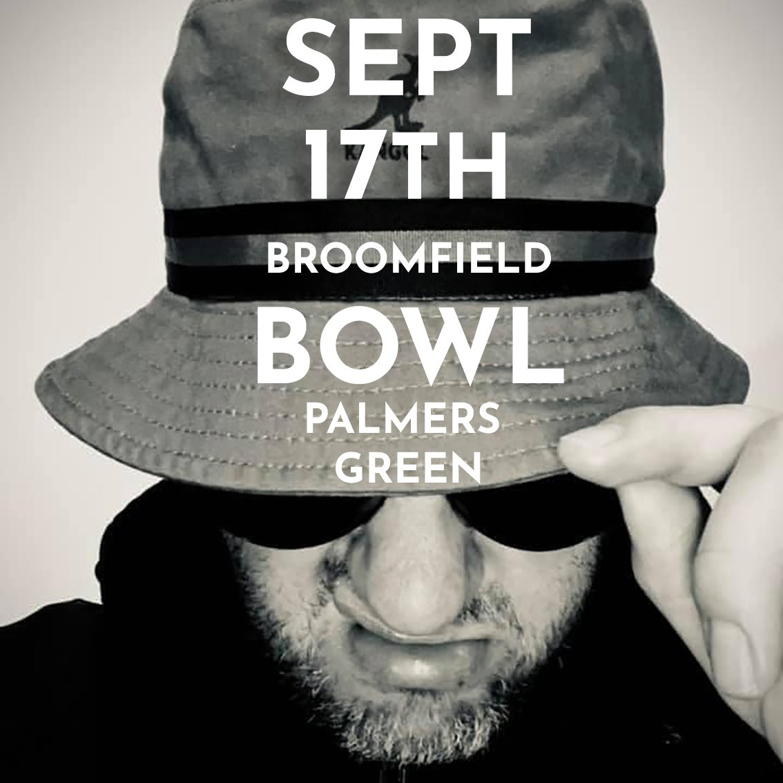 A man covering his face with a hat that says sept 17th broomfield bowl palmers green