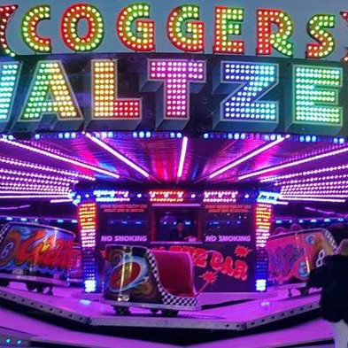 A carnival ride with a sign that says ' cogger 's waltzes ' on it.
