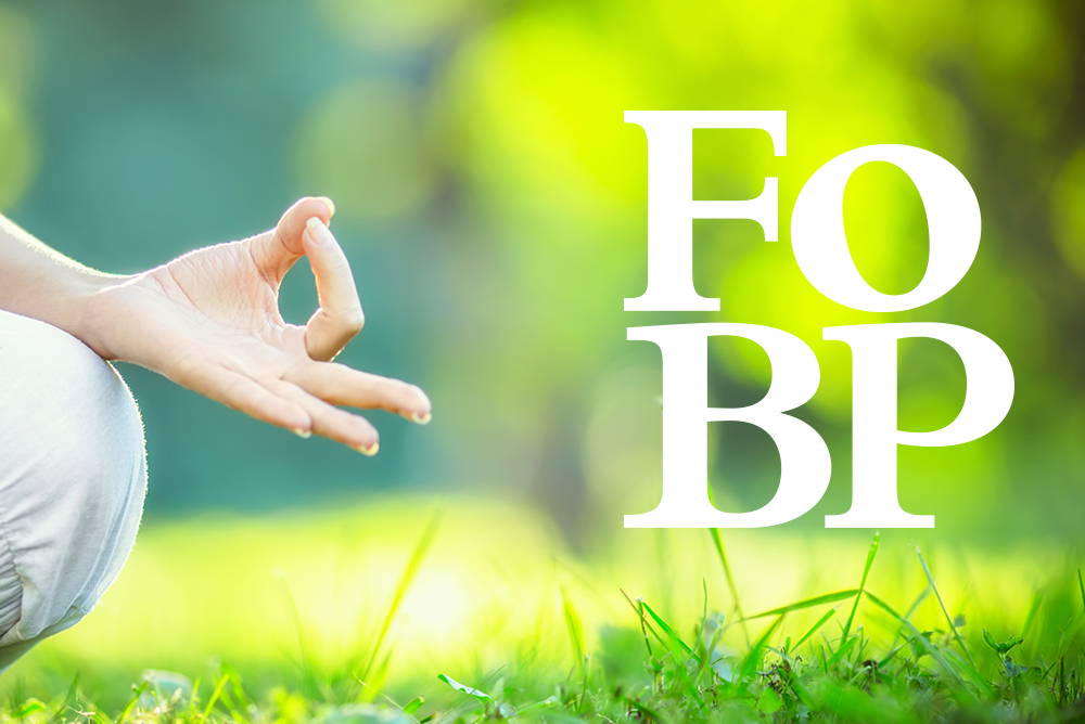Person meditating on grass beside white “FoBP” text over a bright green background