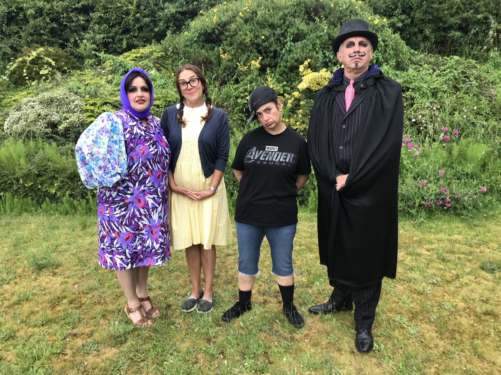 A group of people are posing for a picture in a field.