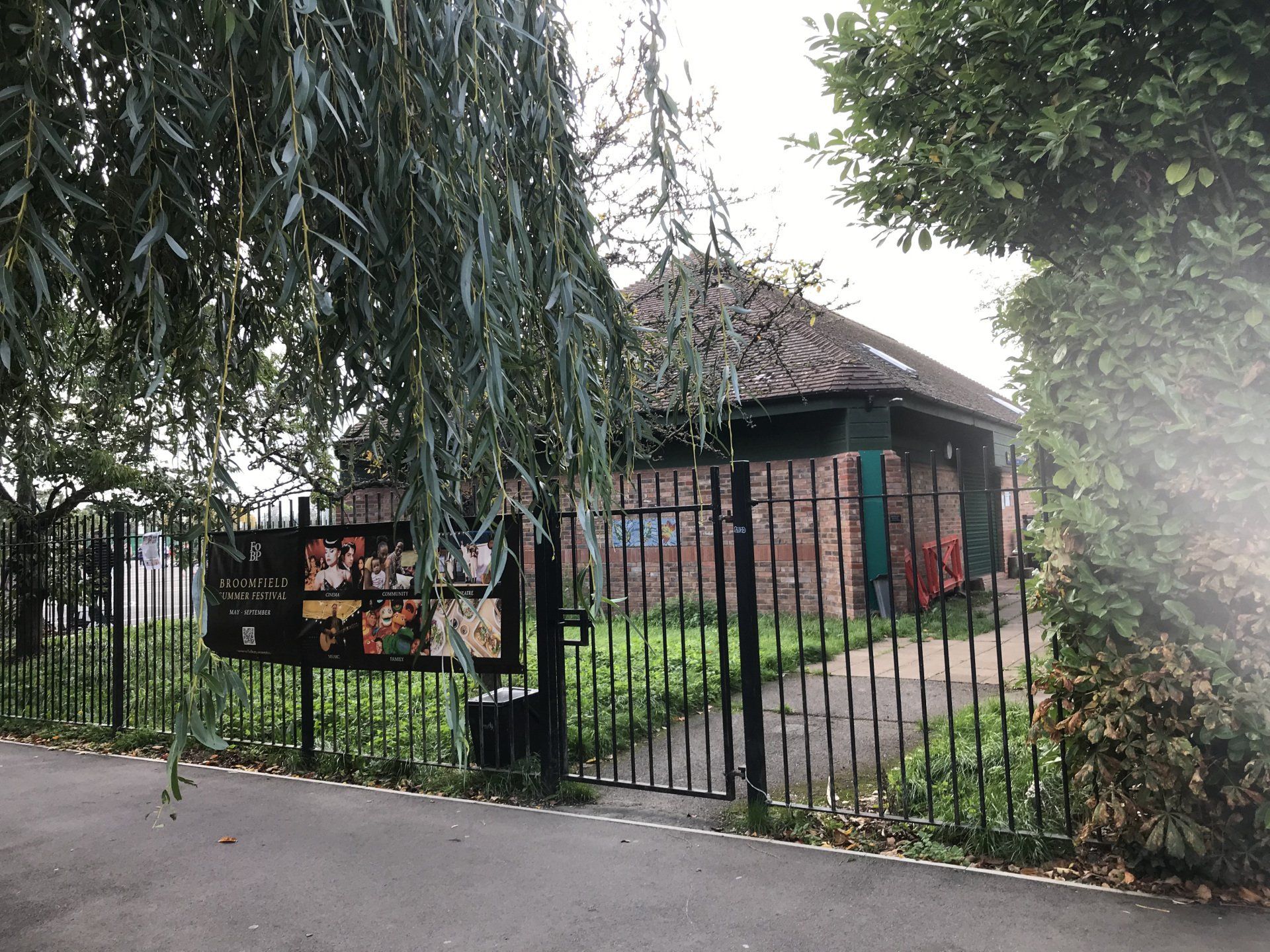 A fenced in area with a building in the background