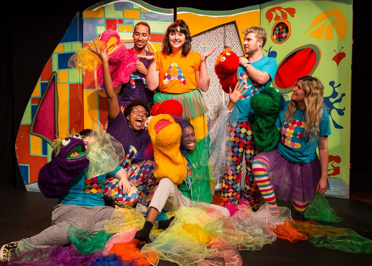 A group of people are posing for a picture on a stage.