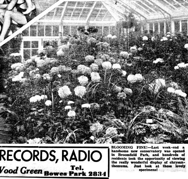 Black-and-white greenhouse packed with blooming flowers; sign reads “RECORDS, RADIO” at bottom.