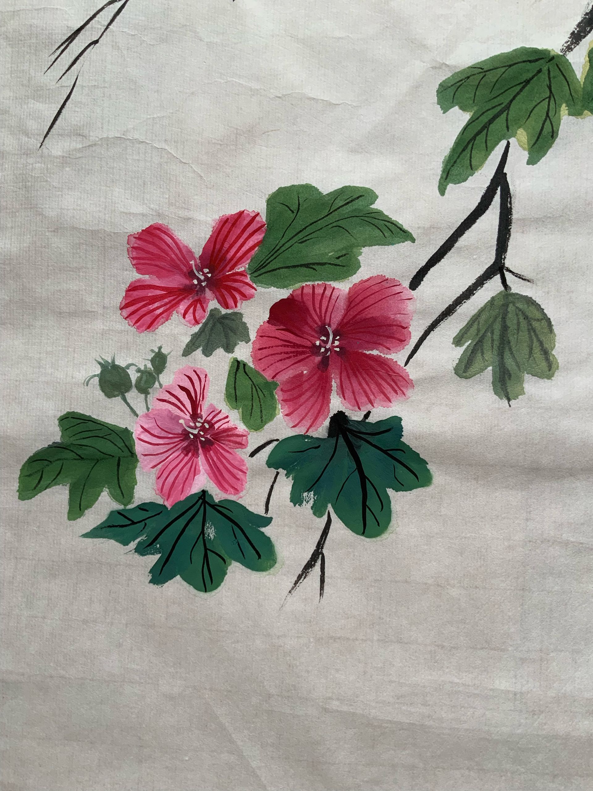 Hand-embroidered pink flowers with green leaves on beige fabric