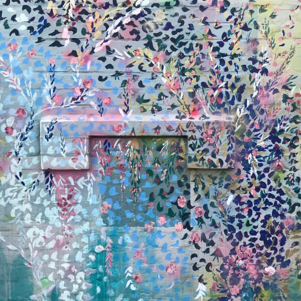 A painting of flowers on a brick wall
