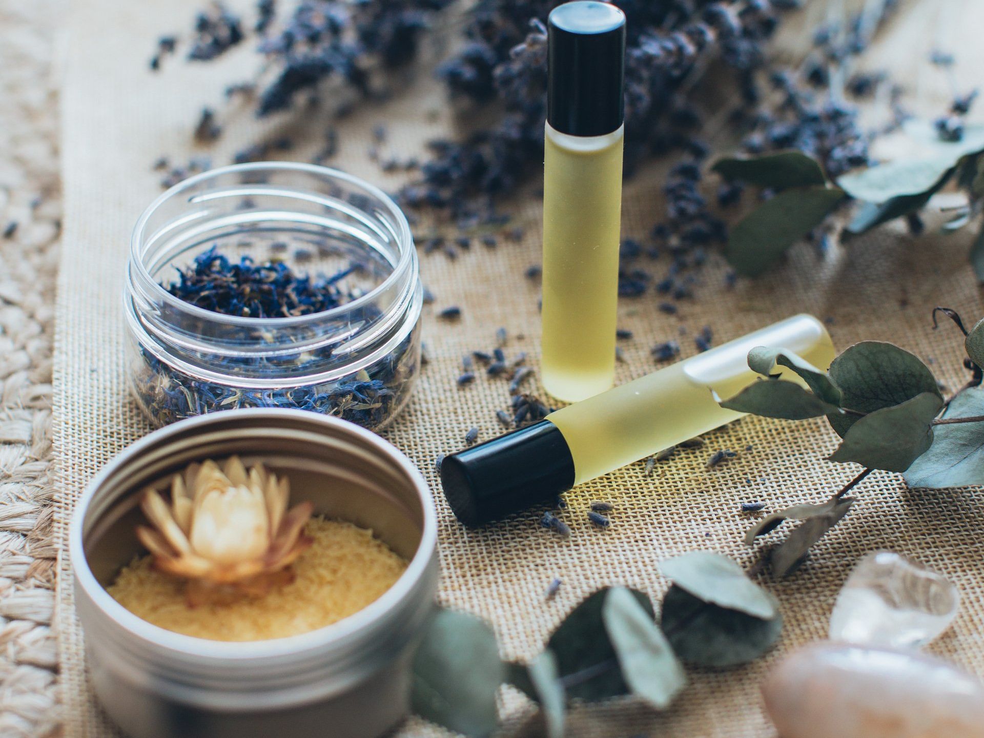 There are many different types of essential oils on the table.