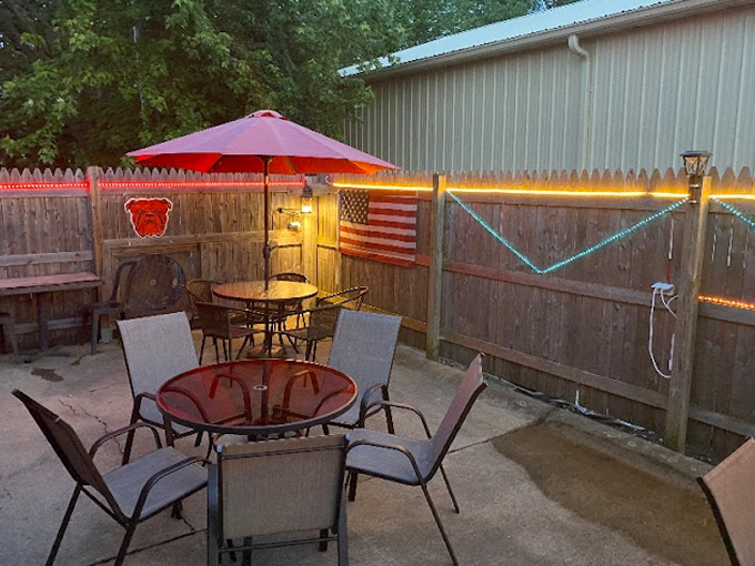 A patio with a table and chairs under an umbrella.