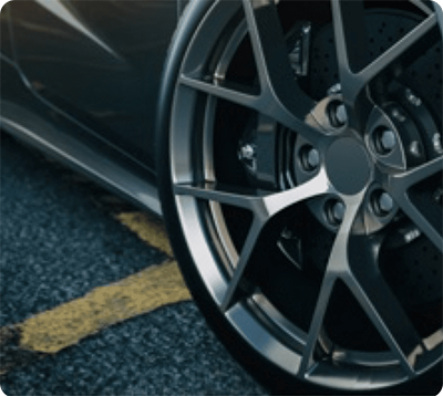 A close up of a car wheel on a road