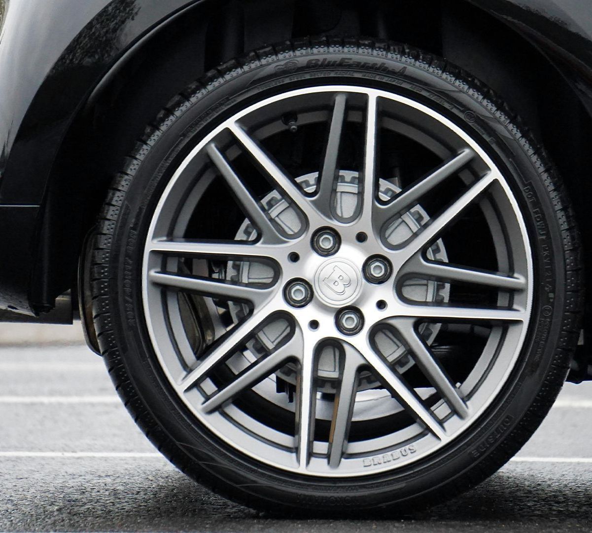 A close up of a car wheel with a tire on it