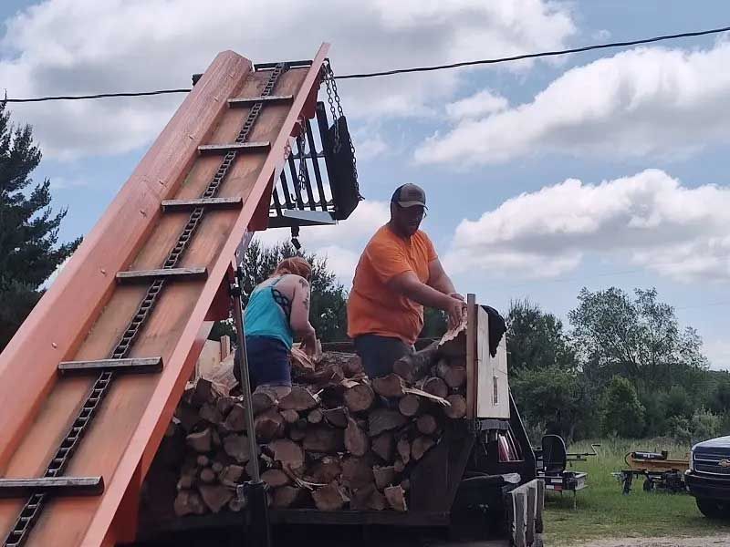  log splitter conveyor with workers loading firewood 3