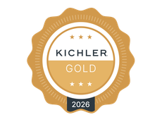A gold scalloped circular award badge with the text 