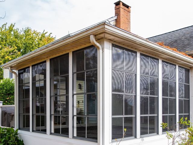 A house with a black roof and three windows