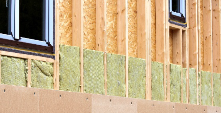 A house is being built with wooden beams and insulation.