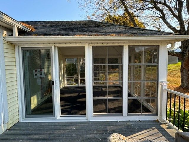 A screened in porch with sliding glass doors
