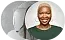 Woman with short, blonde hair smiles, wearing a green top.
