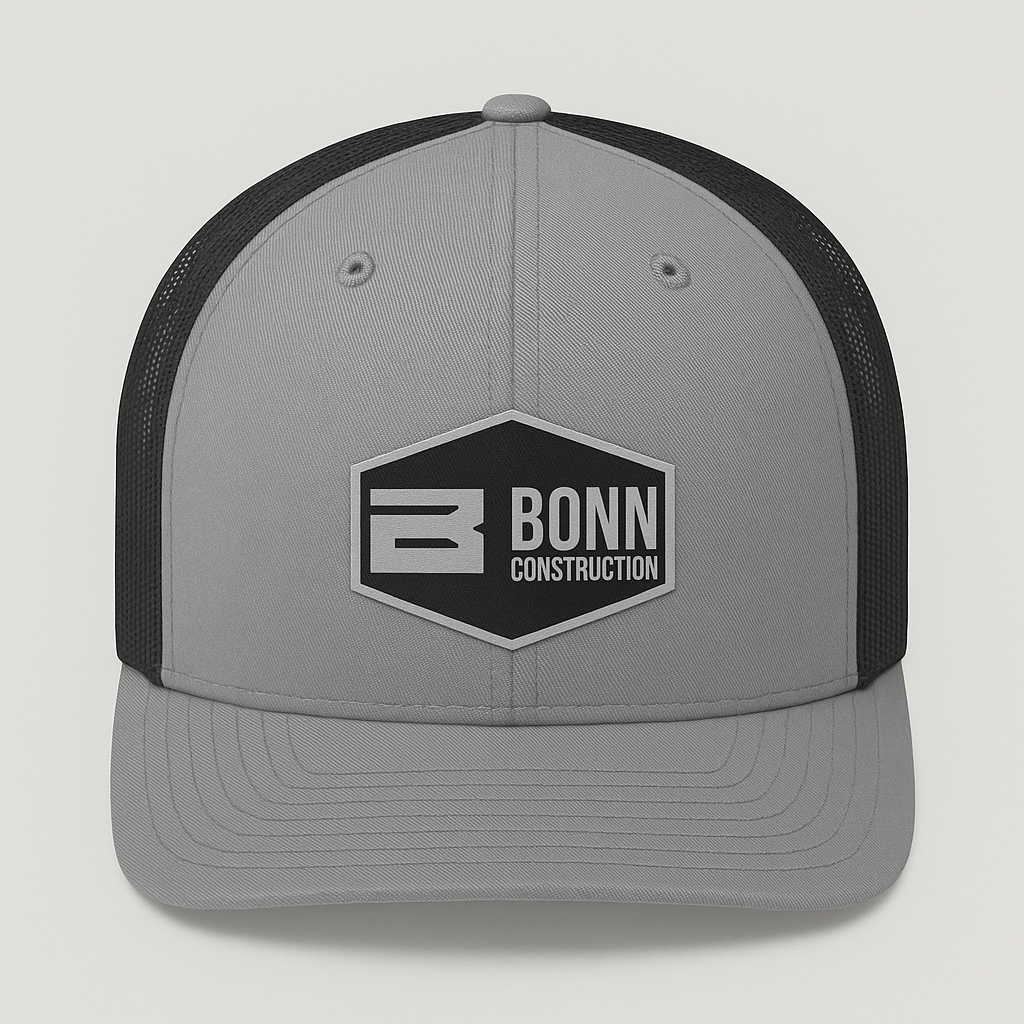 Gray and black trucker hat with "BONN CONSTRUCTION" logo on the front.