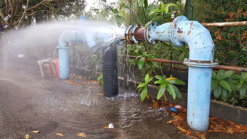 A Water Pipe is Bursting and Spraying Water on the Ground — Subat Plumbing Services in Kurri Kurri, NSW