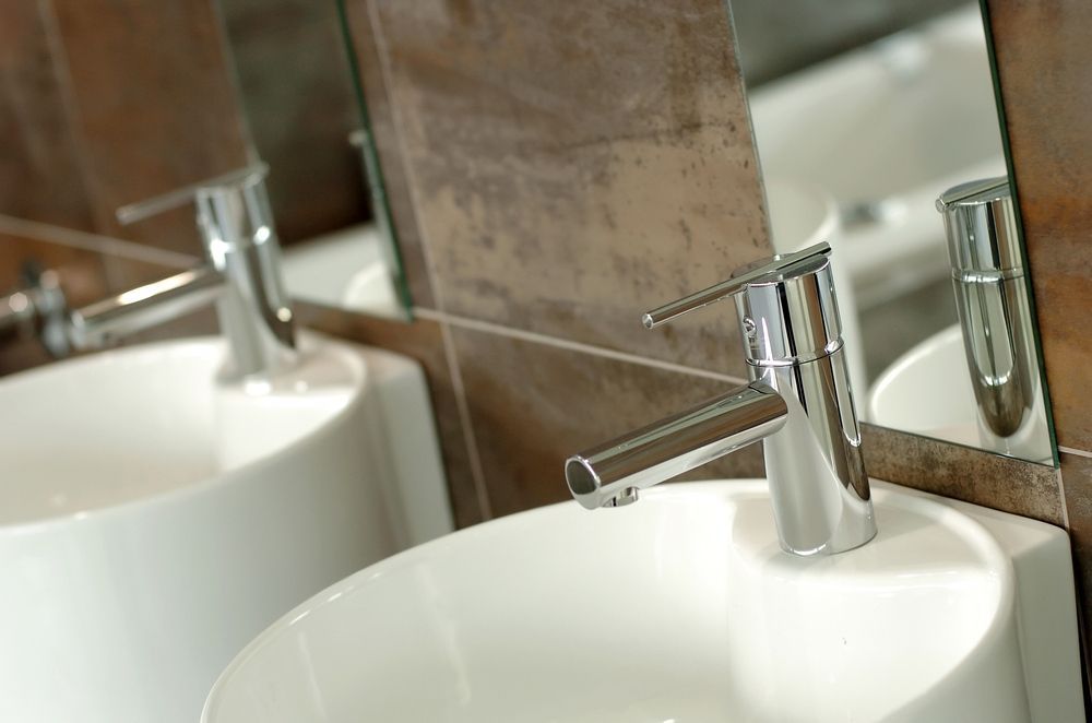 A bathroom with two sinks and a mirror — Subat Plumbing Services in Cessnock, NSW