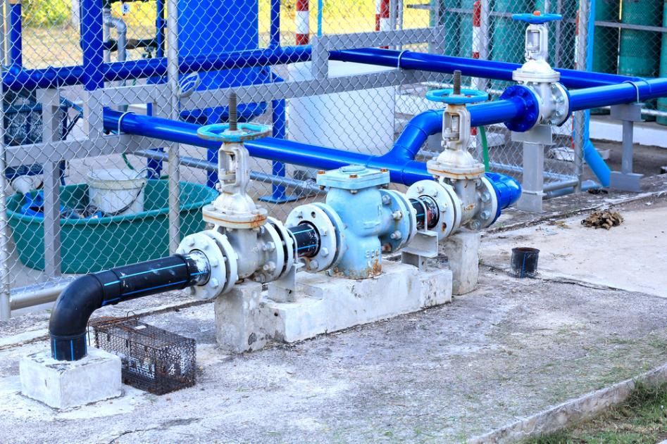 A Bunch of Blue Pipes Are Connected to Each Other in a Factory — Subat Plumbing Services in Maitland, NSW