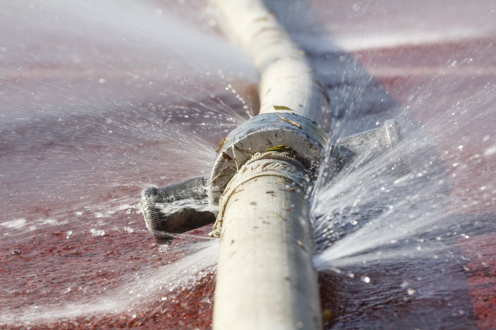 A Close Up of a Broken Water Pipe With Water Spraying Out of It — Subat Plumbing Services in Kurri Kurri, NSW