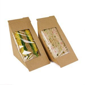 Two kraft paper sandwich wedges with clear plastic windows displaying a sandwich inside, set against a white background.