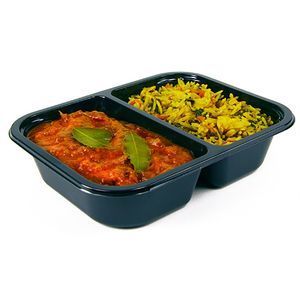 A black plastic partitioned container holding a serving of red curry topped with bay leaves alongside yellow vegetable rice.
