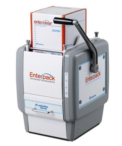 A gray and white Enterpack manual food tray sealing machine with a crank handle, sitting on a white background.