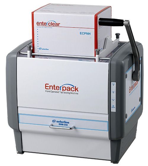 A white and grey Enterpack manual tray sealing machine with a handle and an Enterclear film roll sitting on top.