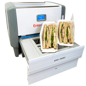 An EHQ-350N2 industrial food packaging machine with an open tray holding two containers of sliced sandwiches.