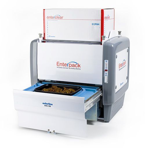 An Enterpack automatic tray sealing machine with an open drawer containing a tray of food, set against a white background.