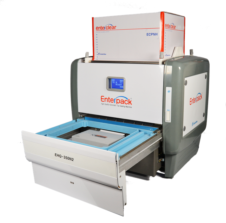 An Enterpack tray sealing machine with a pull-out tray, white casing, and a blue digital display on a white background.