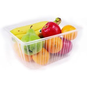 A clear plastic container filled with assorted fresh fruits, including bananas, a green pear, an apple, and citrus.
