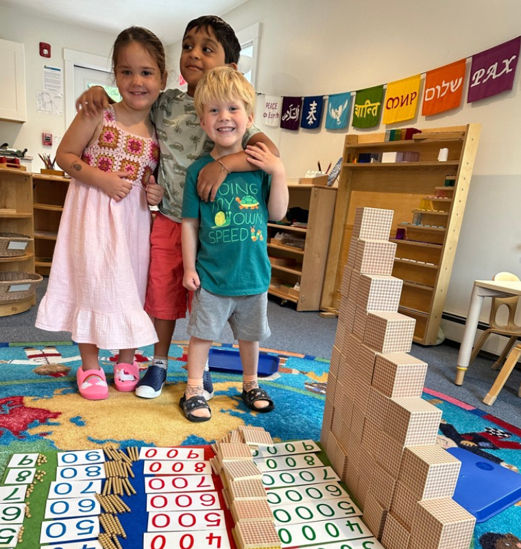 A group of children are in their montessori classroom working on their lessons