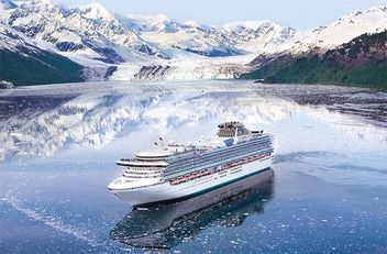 alaskan cruise A cruise ship is floating on top of a body of water with mountains in the background.