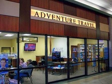 A building with a sign that says adventure travel