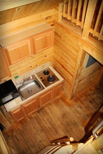 An aerial view of a wooden kitchen with a sink and stove.