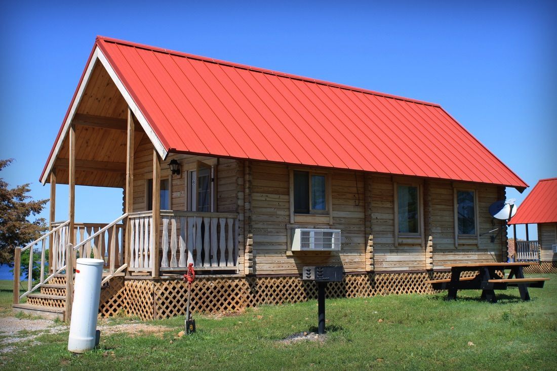 log cabin with a red roof A small log cabin with a red roof