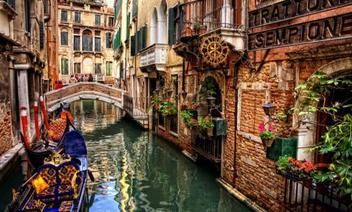 italy canals A gondola is floating down a canal in venice.