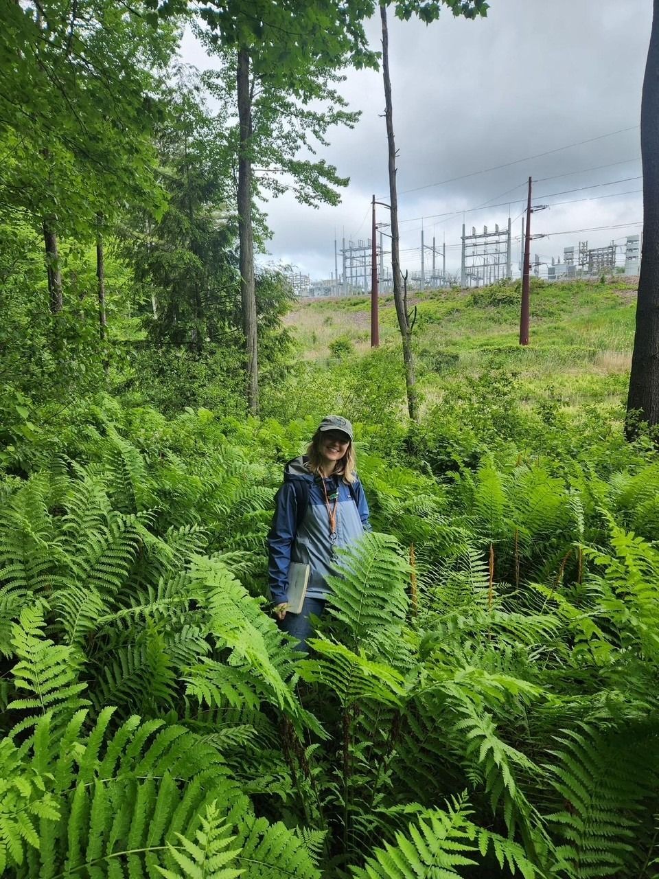Michelle standing in a grove of ferns