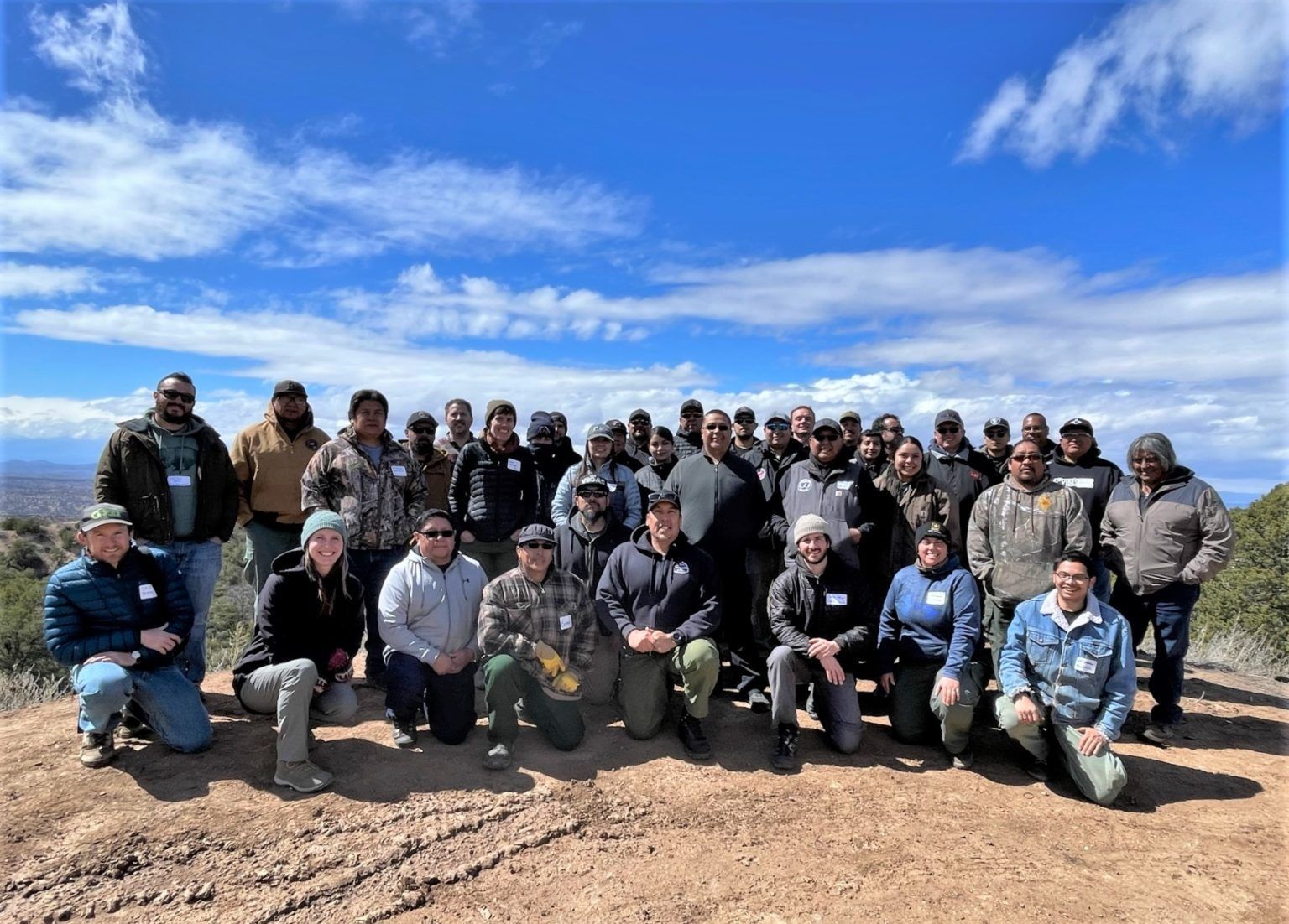 Group photo of workshop collaborators outside on a vista