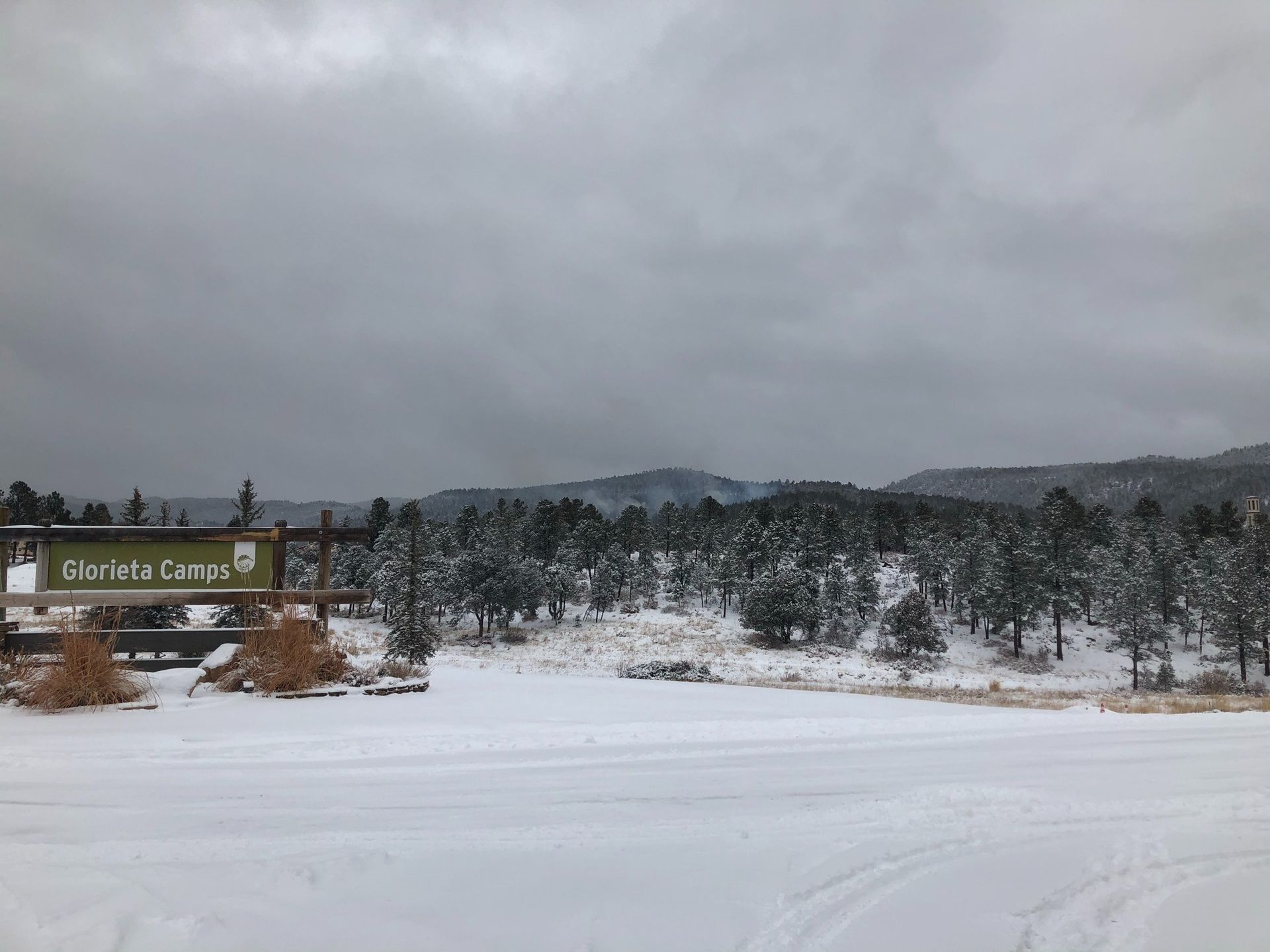Smoke rises above Glorieta Camps from the first prescribed fire burn since 2022.