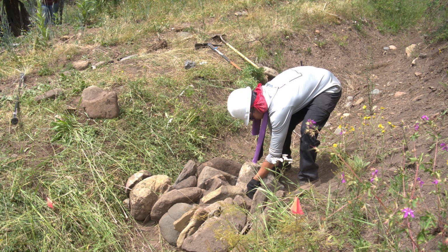 Crew member collecting rocks for a one-rock dam.