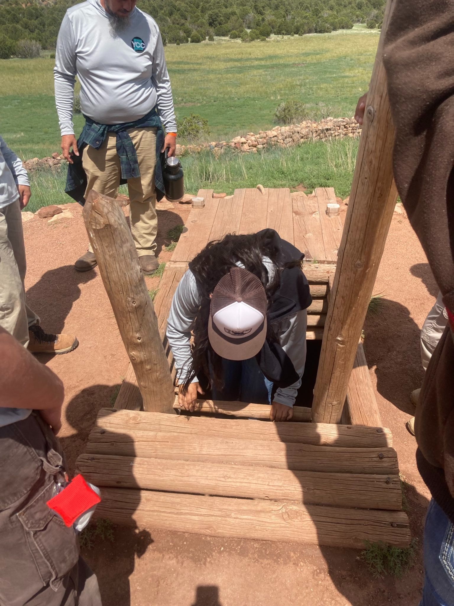 Crew Members entering a Kiva, a space traditionally used for rites and political meetings