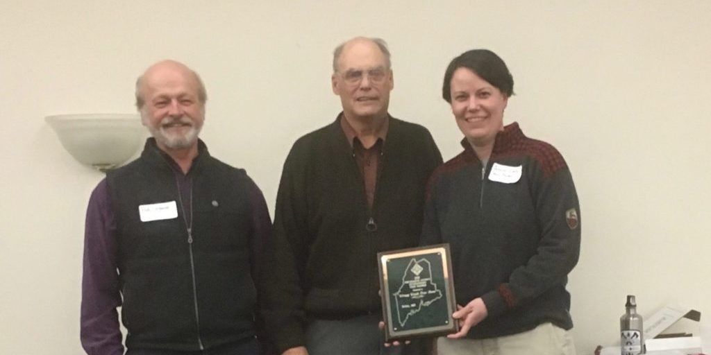 Bob and Jessica receiving the 2018 Piscataquis County Tree Farm of the Year Award from Doug Denico, the