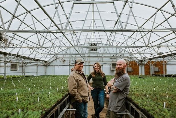 Photo of One Canopy staff in the greenhouse