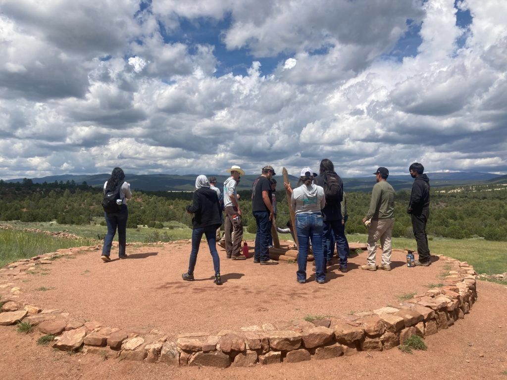Crew Members entering a Kiva, a space traditionally used for rites and political meetings