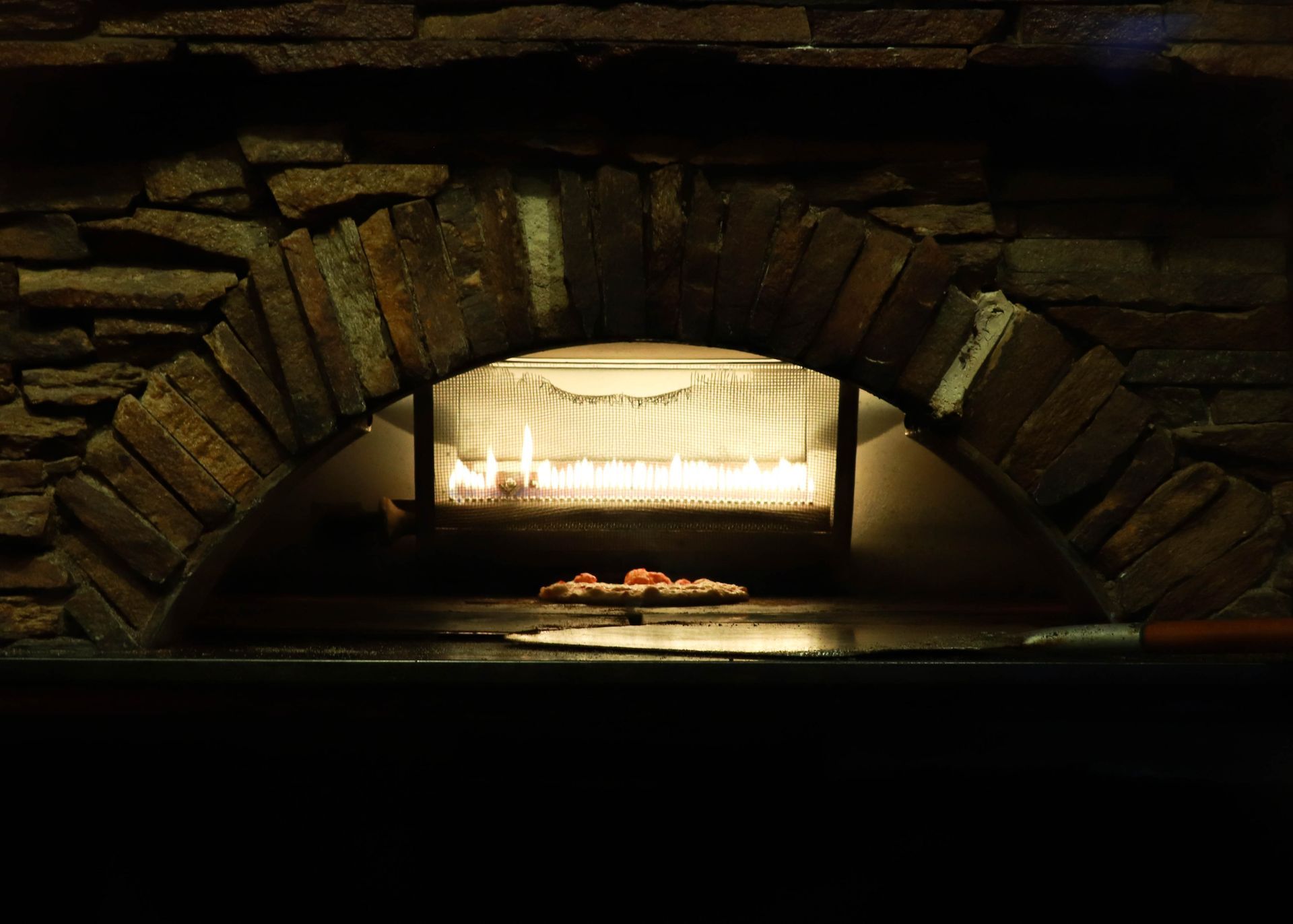 Pizza Cooking Inside of Brick Oven