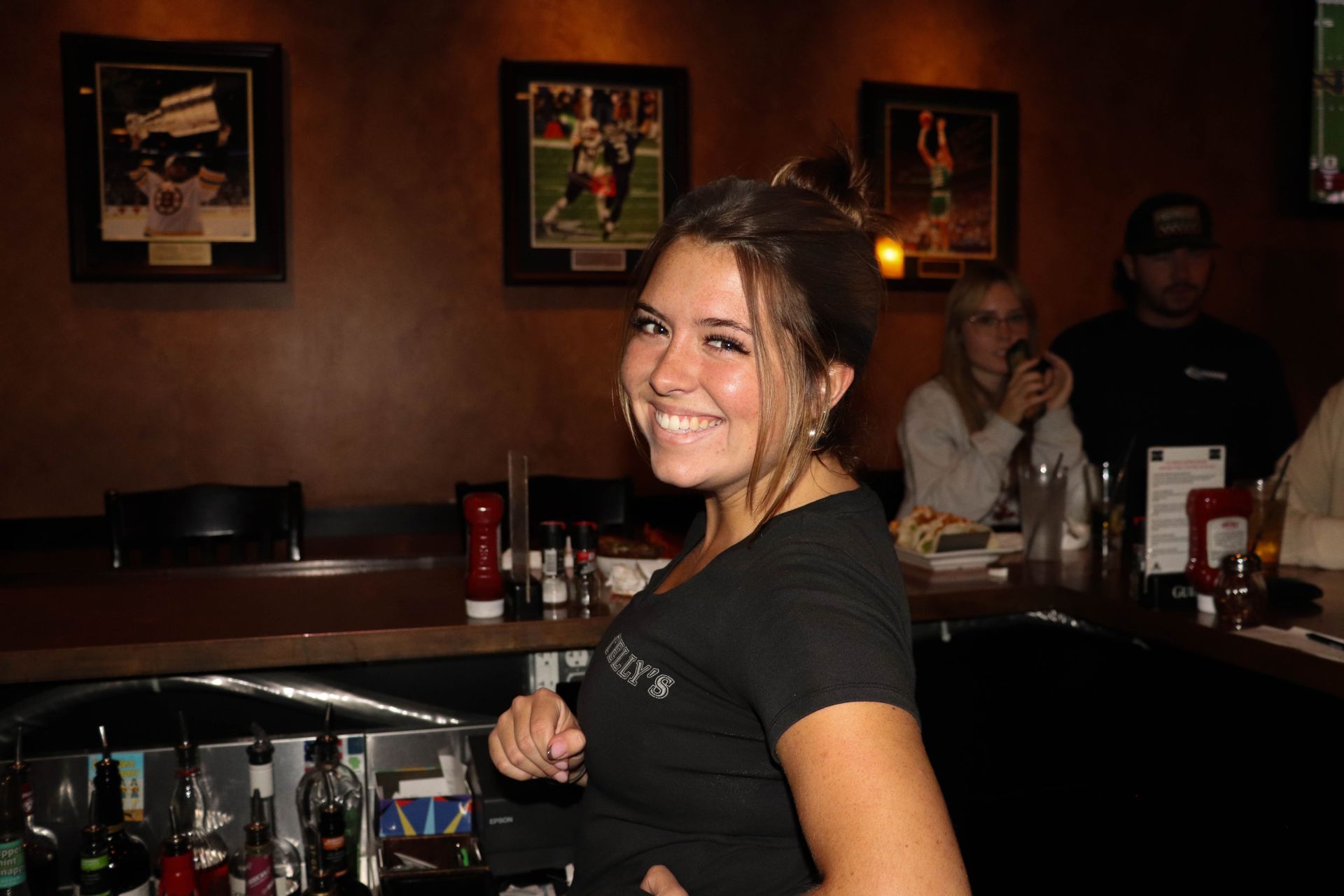 Friendly Bartender and Visitors at Local Pizza Restaurant