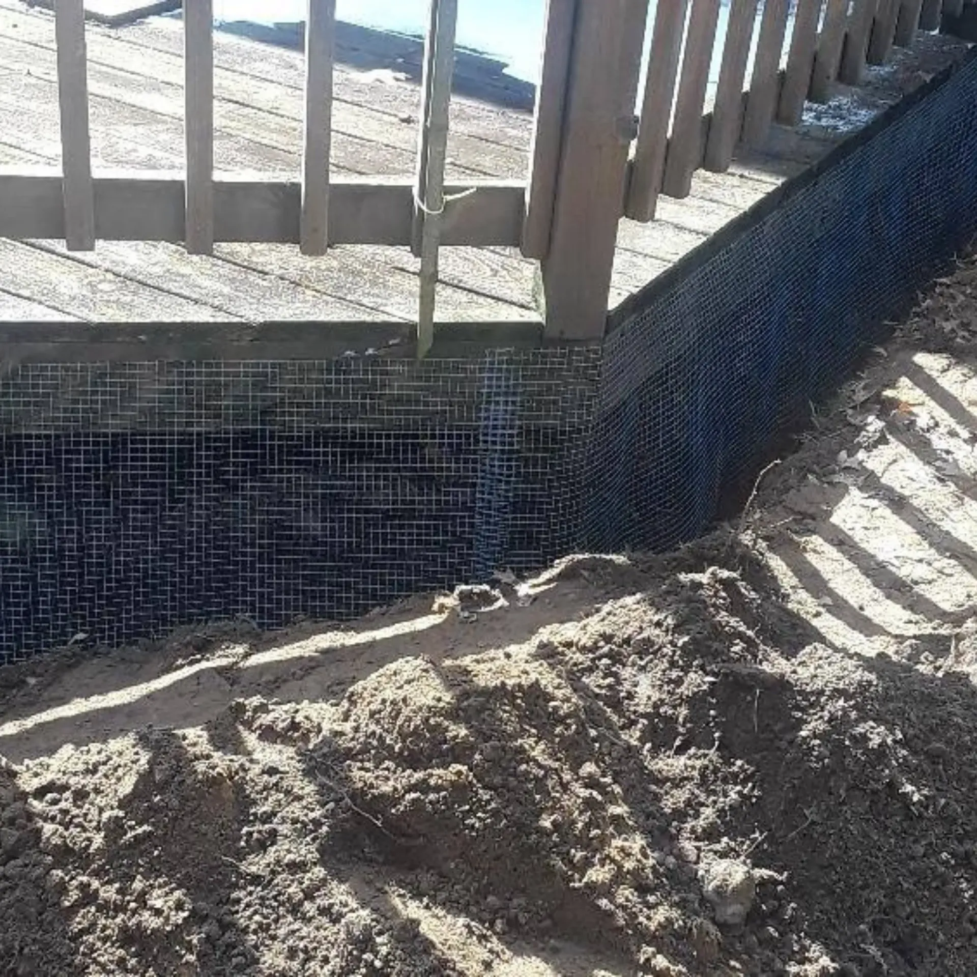 Michigan Wildlife Solutions - A pile of dirt is next to a swimming pool